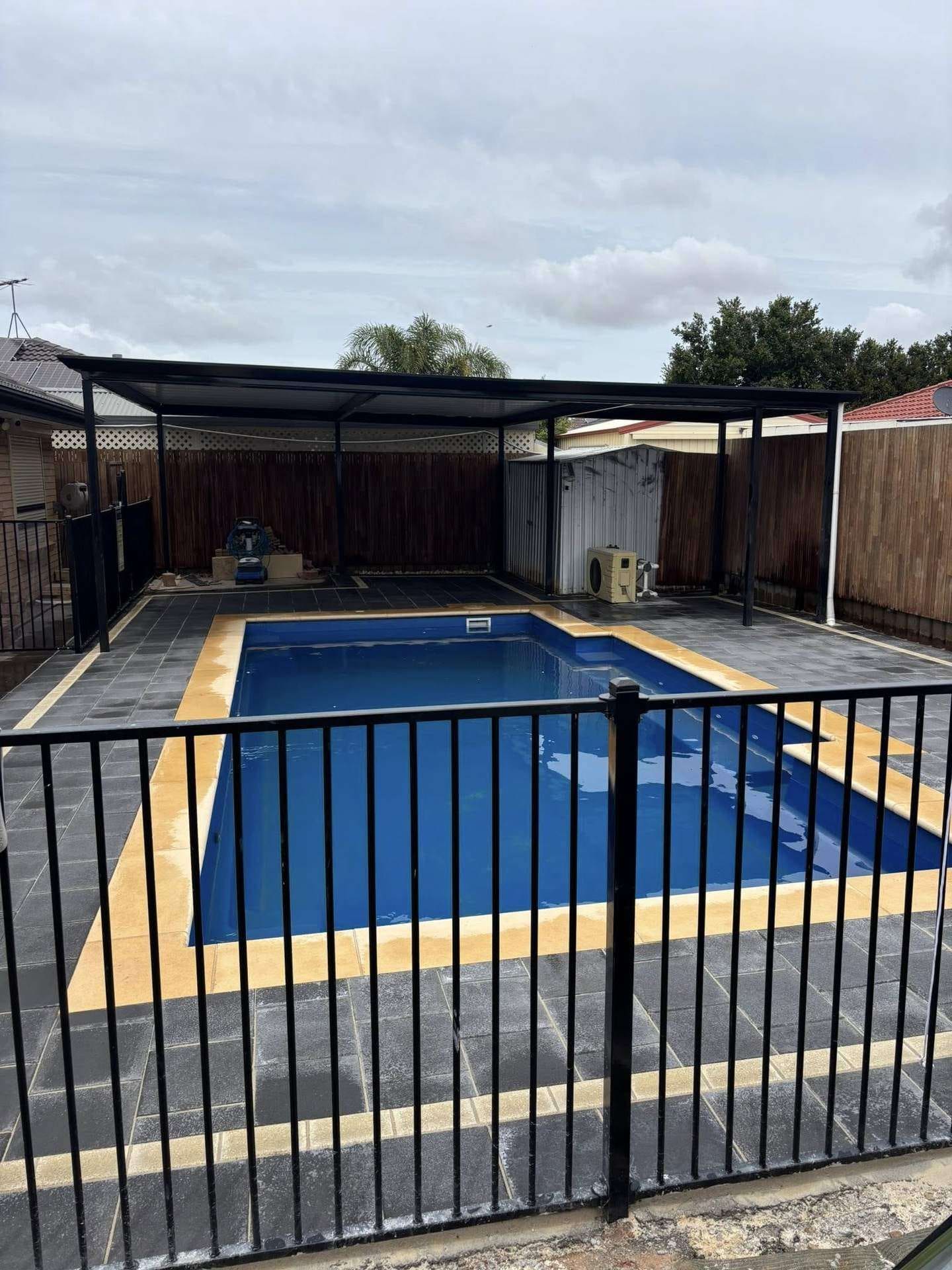 Full view of the fibreglass pool wrapped in new marble-look paving — May Paving